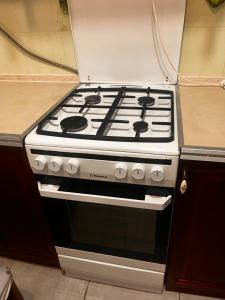 a stove top oven sitting in a kitchen at City Relax 2 in Bălţi