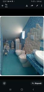 a bathroom with two toilets and a rock wall at Casa dei Pavoni in Monte Gallo