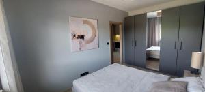 a bedroom with a bed and a mirror at Apartament Podjasnogórski Loretańska in Częstochowa