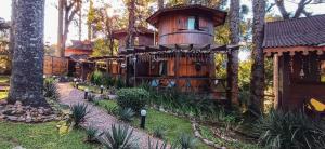 a tree house in the middle of a forest at Chalé Temático em Pipa de Vinho - Parada da Pipa Chalés in Canela