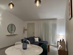 a living room with a blue couch and a table at Finca Avrafina in Tarascon