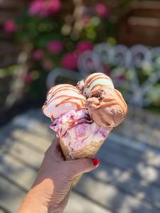 a person holding a ice cream cone with frosting and sprinkles at Langø Fjord Glamping nr 3 in Nakskov