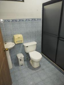 a bathroom with a toilet and a sink at Dollar in Liberia