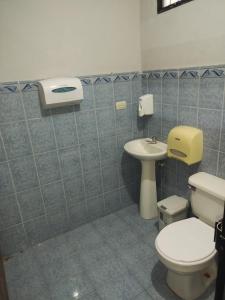 a bathroom with a toilet and a sink at Dollar in Liberia