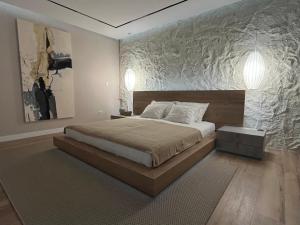 a bedroom with a large bed and a large wall at Apartments Tomislav in Novalja
