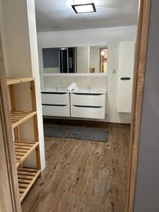 a bathroom with two sinks and a mirror at Pokoje u Niny in Nowe Rumunki +43 photos