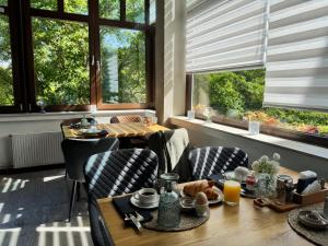 a dining room with a table and chairs and windows at Waldhotel Bad Münstereifel in Bad Münstereifel
