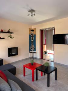 a living room with a couch and a red table at La Casa Del Cuore in Kiveri