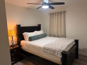 a bedroom with a bed with a ceiling fan at School Village Walk-in shower and jetted tub in Elizabethtown