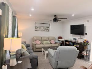 a living room with a couch and a tv at School Village Walk-in shower and jetted tub in Elizabethtown