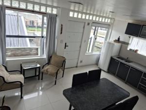 a small living room with a table and chairs at JAP in Río Gallegos