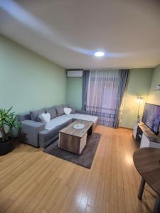 a living room with a couch and a coffee table at Bella Verde in Vrnjačka Banja