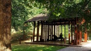 a person sitting in a gazebo in a park at Bella Verde in Vrnjačka Banja