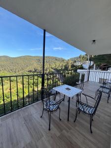 a patio with a table and chairs on a balcony at El Mirador de Espadan in Alcudia de Veo