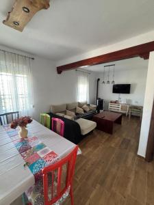 a living room with a table and a couch at El Mirador de Espadan in Alcudia de Veo