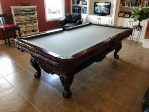 a pool table sitting in a living room with at Depot Inn & Suites in La Plata