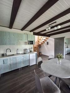 a kitchen with a table and a table and chairs at Bukhouse Carpathians in Krivorovnya