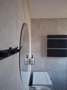 a bathroom with a sink and a mirror at Bukhouse Carpathians in Krivorovnya