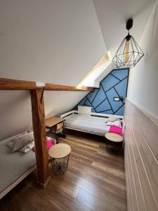 a attic room with two bunk beds and a desk at Apartamenty Kadłubek in Wisła +34 photos
