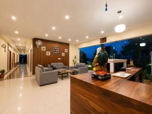 a living room with a couch and a table at The Hill Heaven A Luxury Property With Balcony & Mountain View Rooms in Mussoorie