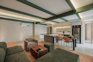 a living room with a couch and a table at Gres Apartments Medellin in Medellín