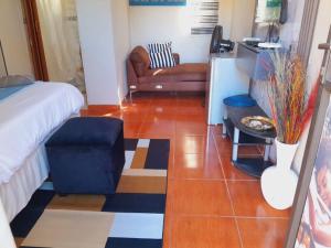 a living room with a bed and a couch at Ecogreen on End in Northam