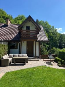 a house with a couch on a brick patio at Apartamenty Kadłubek in Wisła