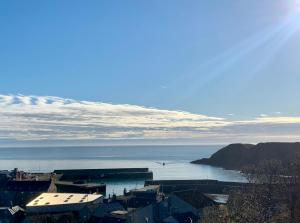 a view of a city with the ocean in the background at The Auld Bakehouse in Stonehaven