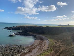 an aerial view of a beach and the ocean at The Auld Bakehouse in Stonehaven