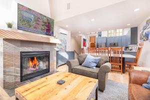 a living room with a fireplace and a table at First Tracks Townhome in Solitude