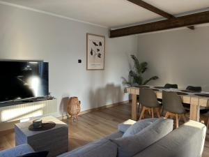 a living room with a couch and a table at Stodoła in Postomino