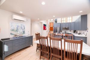 a kitchen with blue cabinets and a table and chairs at First Tracks Townhome in Solitude
