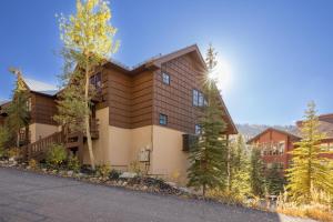 a large building with trees in front of it at First Tracks Townhome in Solitude