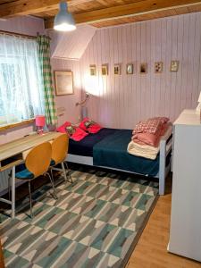 a small bedroom with a bed and a desk at Willa 7 in Korbielów +277 photos
