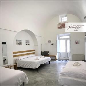 a hotel room with two beds and a window at Rebecca e Sofia Stone House affittacamere in Alberobello