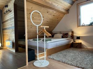a bedroom with a bed in a room with wooden walls at Vikend kuća Millina in Sumbulovac