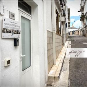 a building with a door on the side of a street at Rebecca e Sofia Stone House affittacamere in Alberobello