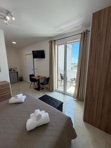 a hotel room with a bed with towels on it at Lu Sule lu Mare le Luci in Scorrano