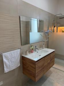 a bathroom with a sink and a mirror at Lu Sule lu Mare le Luci in Scorrano +77 photos