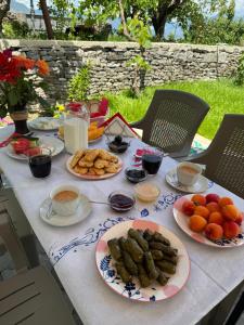 a table with plates of food on it at Guest House Mene in Gjirokastër