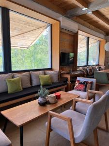 a living room with a couch and a table at Vikend kuća Millina in Sumbulovac