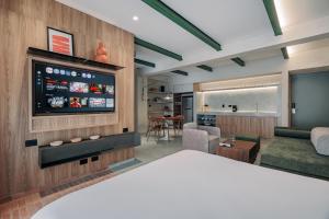 a living room with a flat screen tv on a wall at Gres Apartments Medellin in Medellín