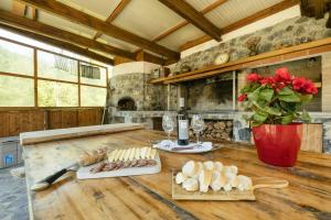 a kitchen with a wooden table with food and wine glasses at VILLA EMILY in Framura