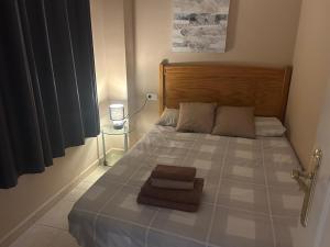 a bedroom with a large bed with a wooden headboard at Beach front apartment with stunning ocean views! in Costa Calma +40 photos