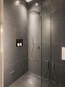a bathroom with a shower with a glass door at Zador Hotel in Ksamil