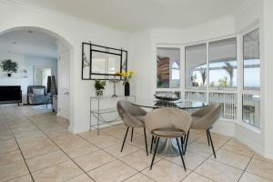 a dining room with a table and chairs at Cassa Dunnage At Pezula in Knysna +37 photos