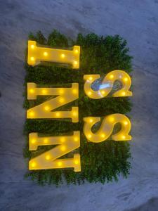 a sign that says zebra with lights on it at ss luxe inn in Guntūr