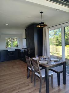 a kitchen and dining room with a table and chairs at Meadow Suite in Lahinch