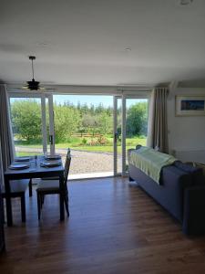 a living room with a bed and a table and a couch at Meadow Suite in Lahinch