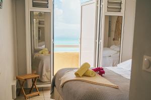 a bedroom with a bed with a view of the ocean at La Perle Fleur d'Epée in Le Gosier